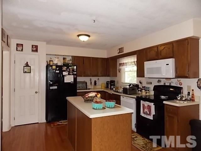 7316 Massachusetts Court Raleigh, NC 27615 - Photo 8 of 16 a kitchen with granite countertop a refrigerator stove and sink