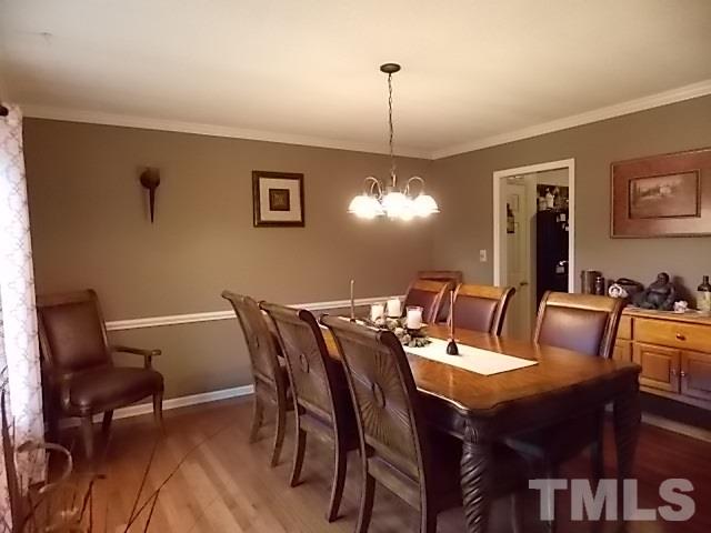 7316 Massachusetts Court Raleigh, NC 27615 - Photo 10 of 16 a view of a dining room with furniture window and wooden floor