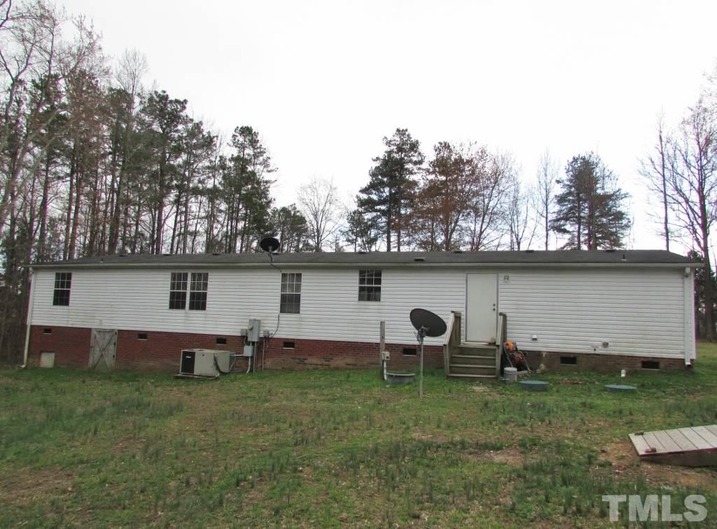 591 Allie Clay Road Roxboro, NC 27573 - Photo 13 of 16 a backyard of a house with table and chairs