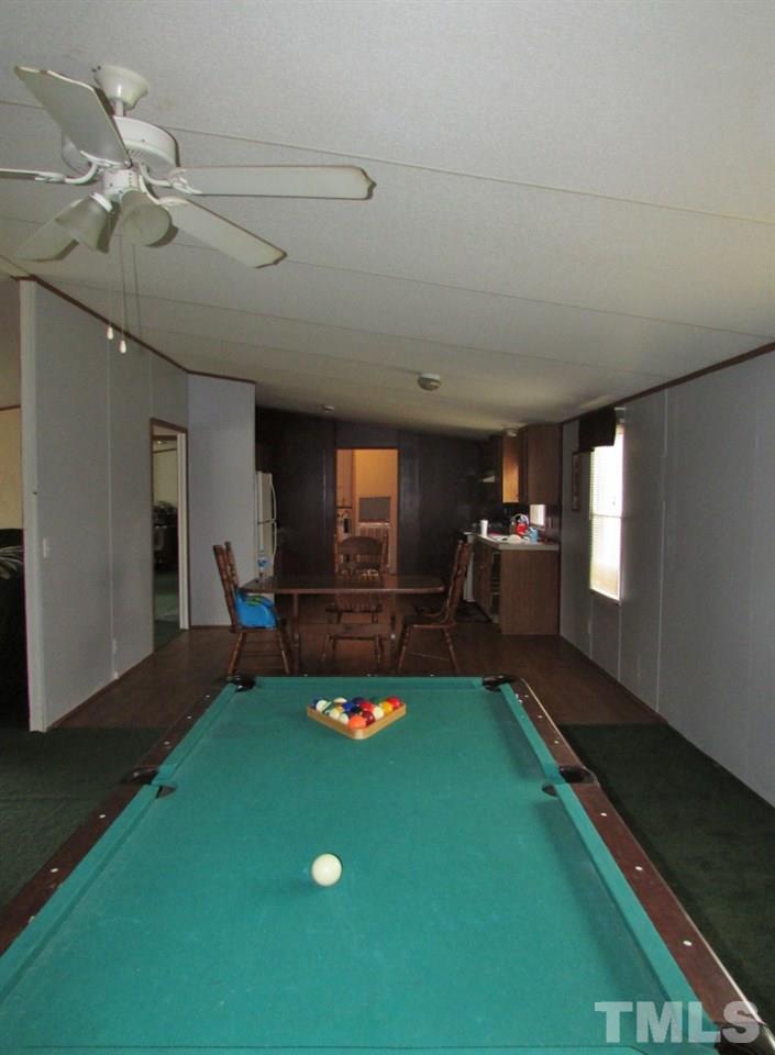 591 Allie Clay Road Roxboro, NC 27573 - Photo 5 of 16 a living room with furniture floor to ceiling window and a table