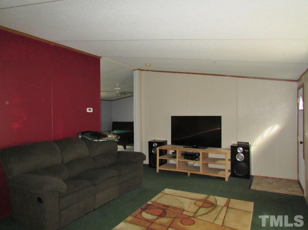 591 Allie Clay Road Roxboro, NC 27573 - Photo 6 of 16 a living room with furniture and a flat screen tv