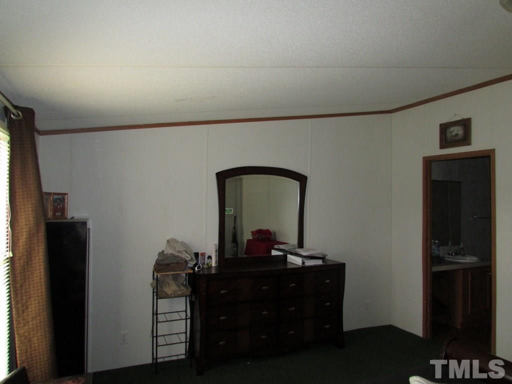 591 Allie Clay Road Roxboro, NC 27573 - Photo 8 of 16 a room with a table and a mirror