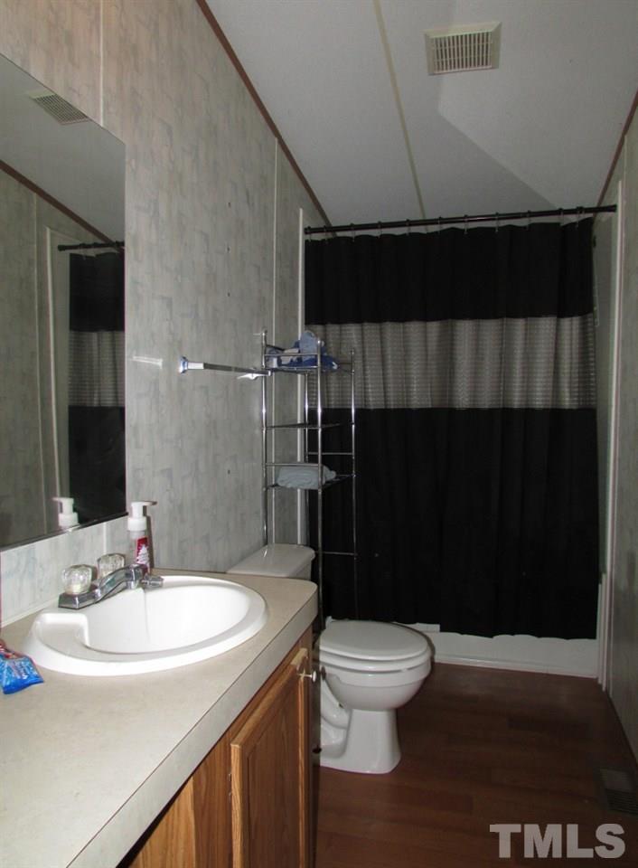 591 Allie Clay Road Roxboro, NC 27573 - Photo 9 of 16 a bathroom with a sink and a toilet