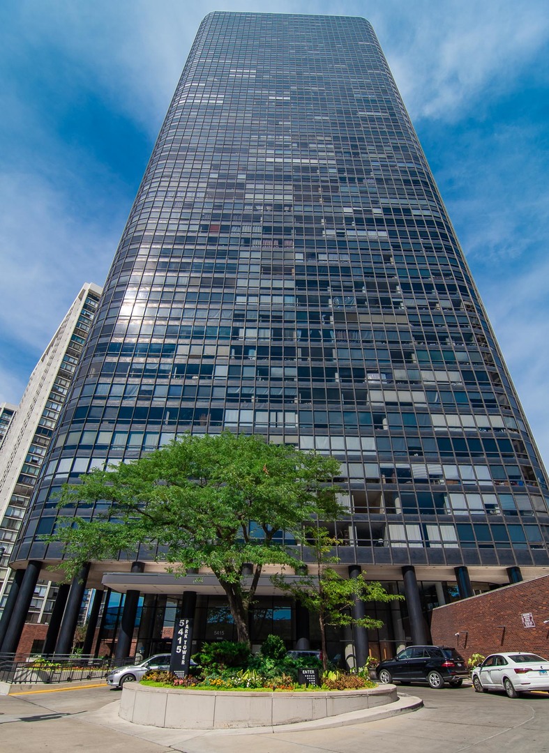5415 North Sheridan Road, Unit 3808 Chicago, IL 60640 - Photo 1 of 16 a front view of a building and car parked