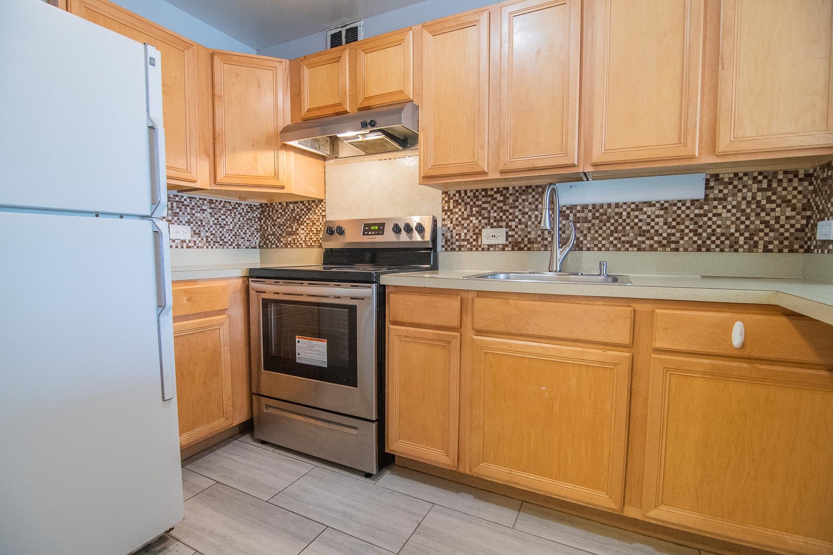 5415 North Sheridan Road, Unit 3808 Chicago, IL 60640 - Photo 6 of 16 a kitchen with cabinets and window