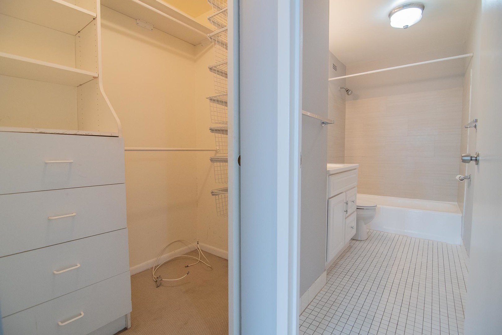5415 North Sheridan Road, Unit 3808 Chicago, IL 60640 - Photo 9 of 16 a bathroom with a granite countertop shower and a toilet