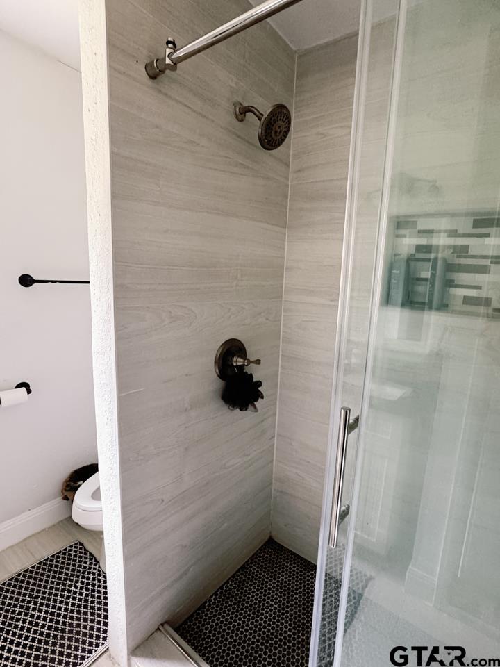 2411 Rodge Drive Tyler, TX 75701 - Photo 23 of 42 a bathroom with a sink toilet and shower