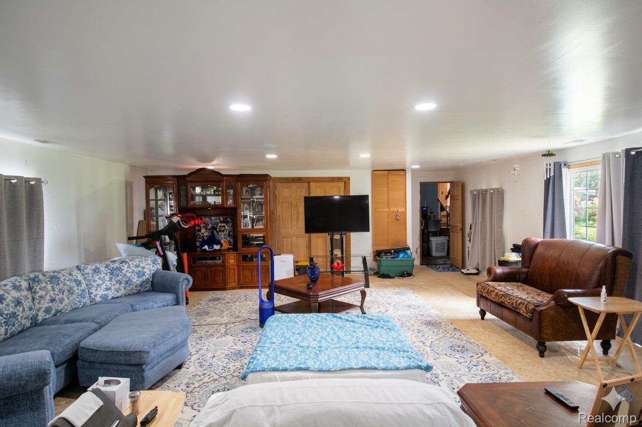 2568 Valentine Road Lapeer, MI 48446 - Photo 27 of 42 Spacious open-concept living area featuring recessed ceiling lighting, wood-finish flooring throughout, and multiple seating zones