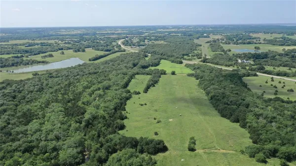 an aerial view of a houses with a yard