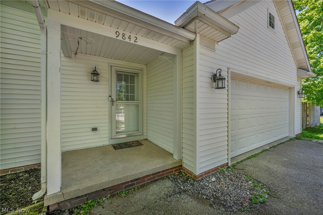 9842 Johnnycake Ridge Road Mentor, OH 44060 - Photo 4 of 40 White siding exterior with a covered porch entry
