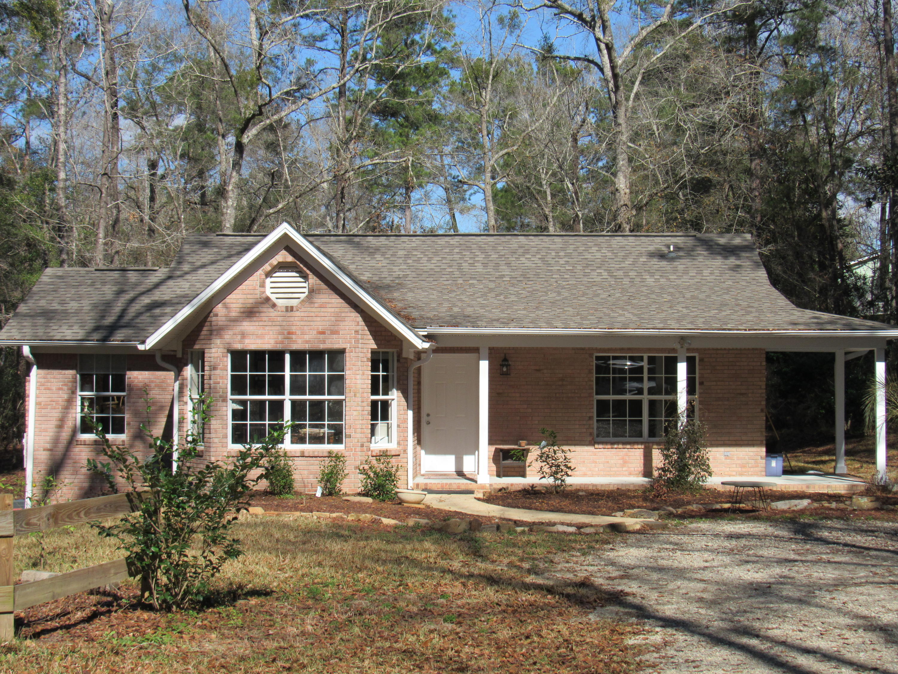 4736 Bob Sikes Road DeFuniak Springs, FL 32435 - Photo 1 of 16 a view of a house with a yard and large tree