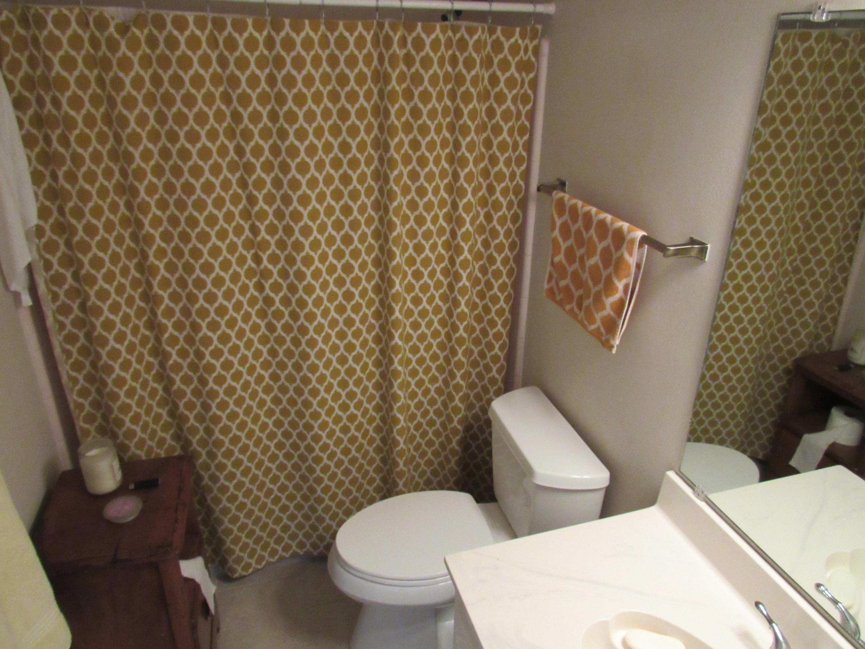 4736 Bob Sikes Road DeFuniak Springs, FL 32435 - Photo 12 of 16 a white toilet sitting next to a shower curtain
