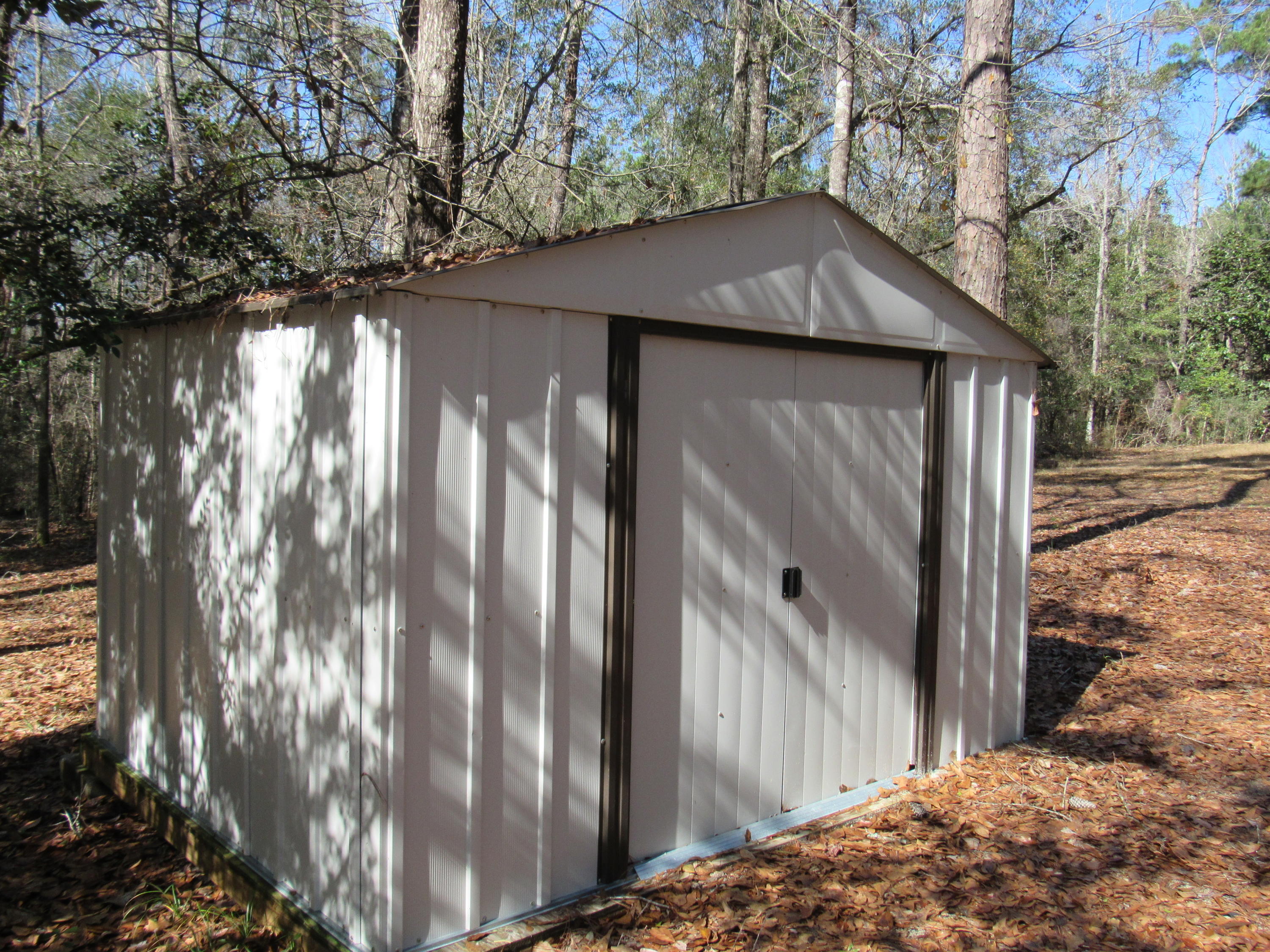 4736 Bob Sikes Road DeFuniak Springs, FL 32435 - Photo 14 of 16 a side view of a house with a yard