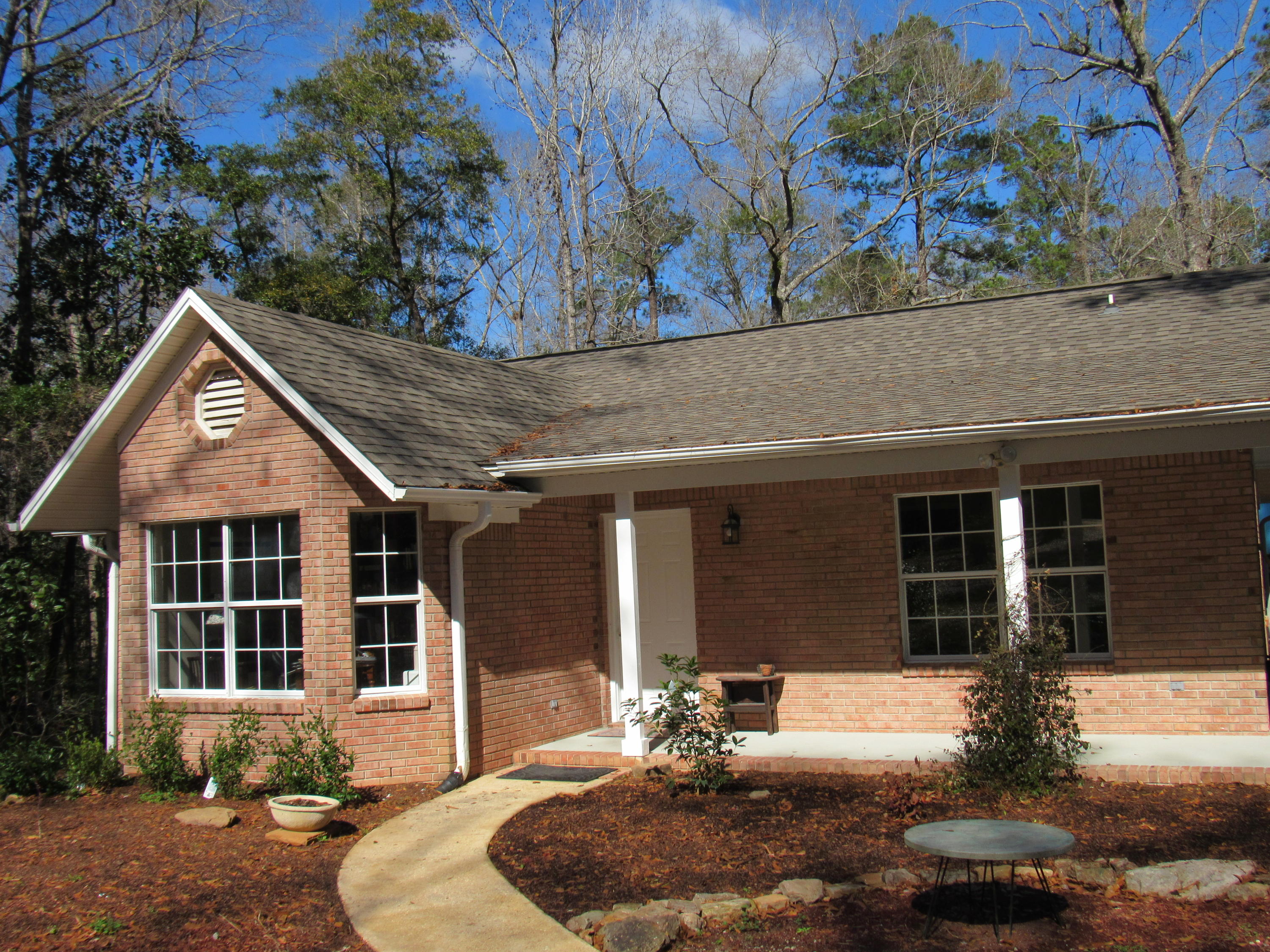 4736 Bob Sikes Road DeFuniak Springs, FL 32435 - Photo 16 of 16 a front view of a house with garden and patio