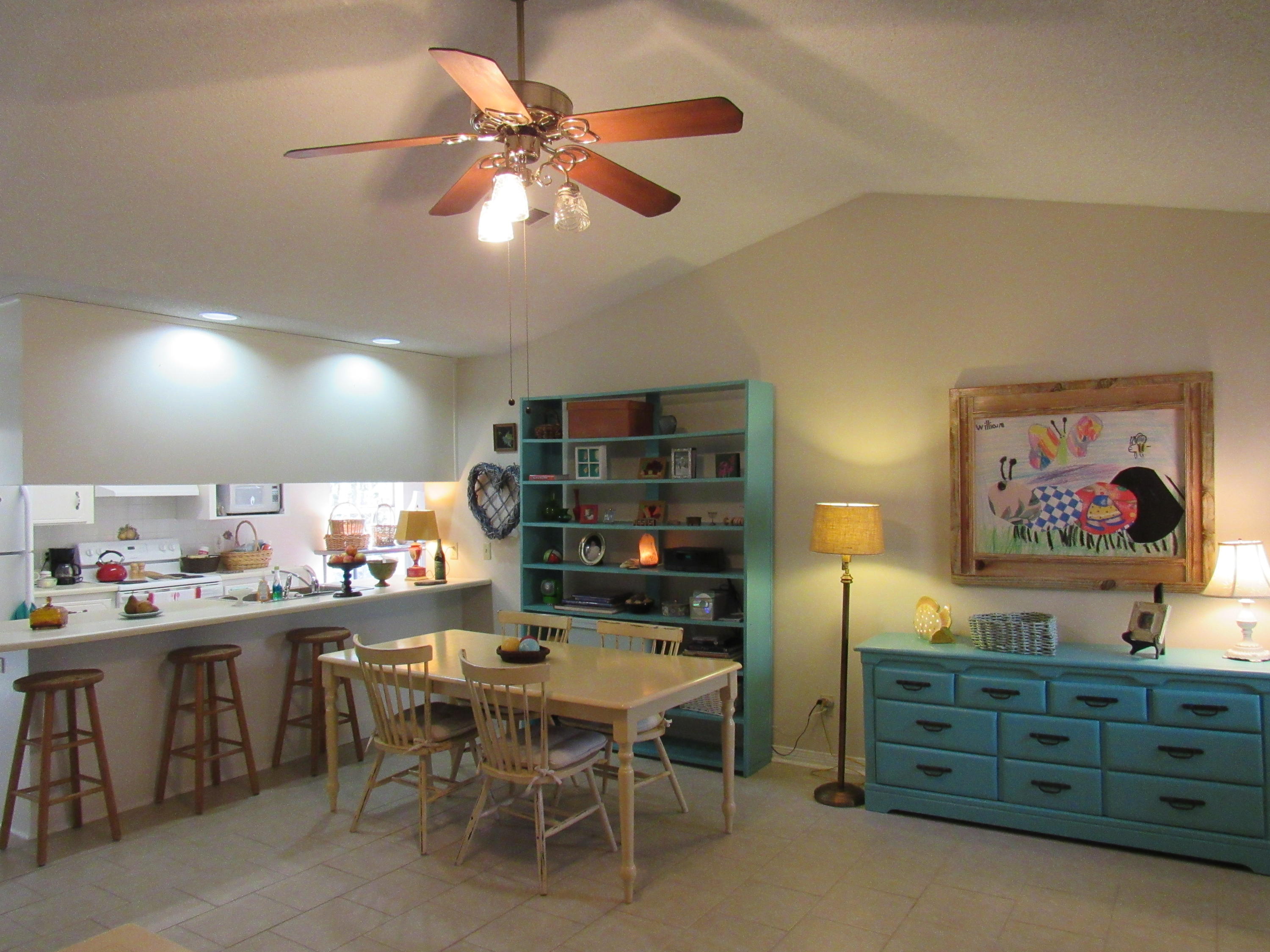 4736 Bob Sikes Road DeFuniak Springs, FL 32435 - Photo 2 of 16 a room with stainless steel appliances kitchen island granite countertop a table chairs and a refrigerator