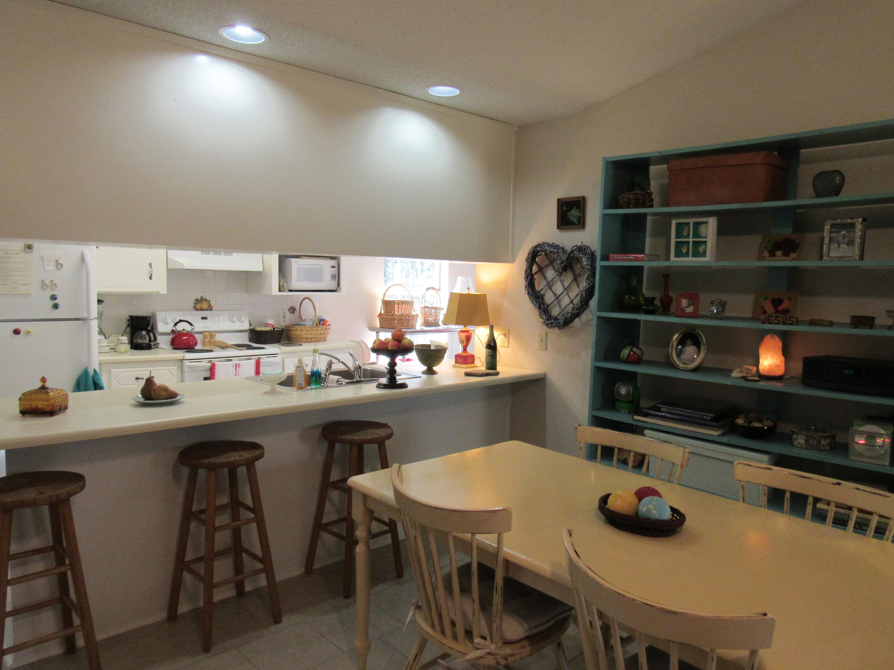 4736 Bob Sikes Road DeFuniak Springs, FL 32435 - Photo 4 of 16 a kitchen with stainless steel appliances a stove a sink a table and chairs