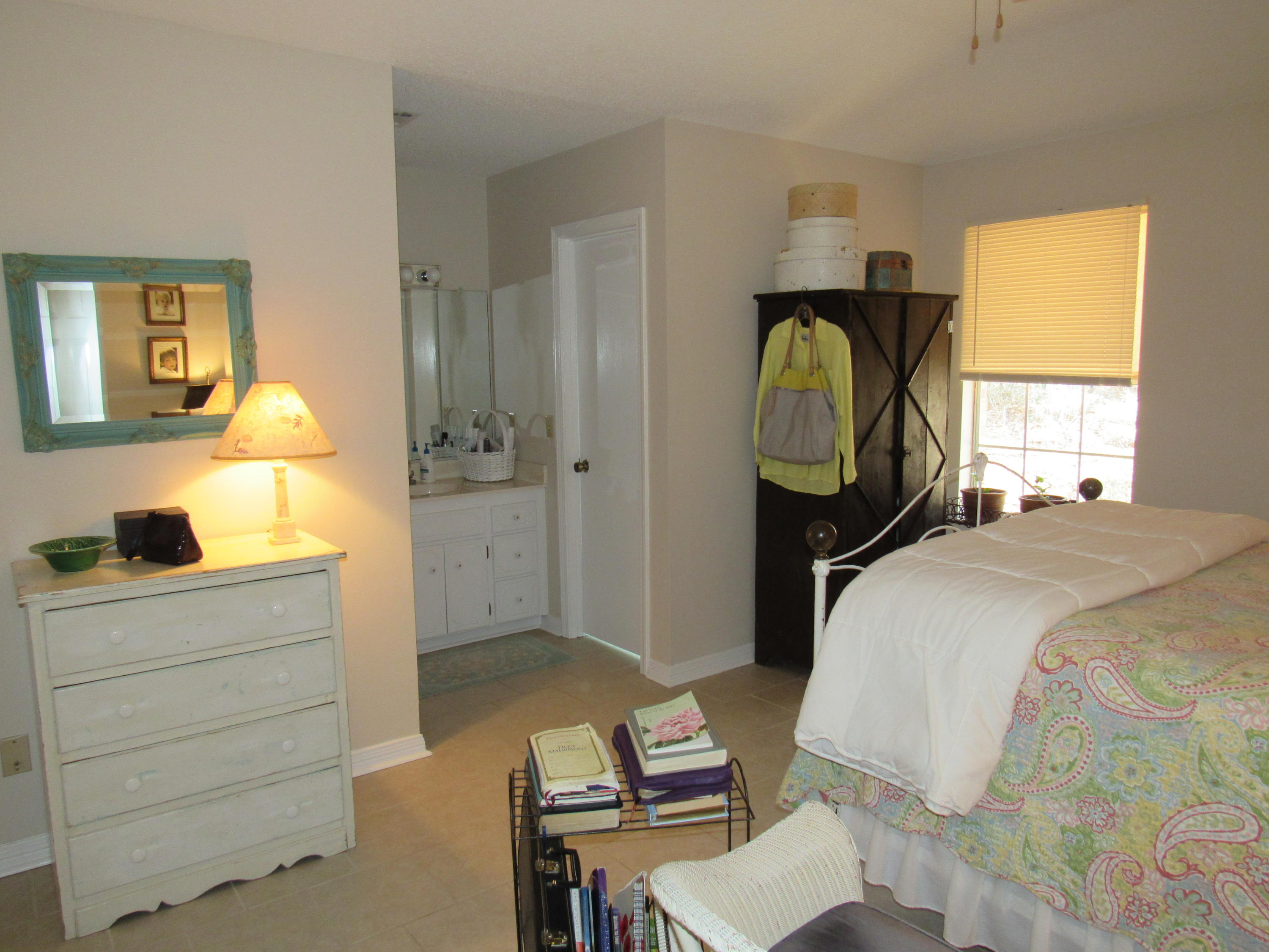4736 Bob Sikes Road DeFuniak Springs, FL 32435 - Photo 10 of 16 a bedroom with a bed and a dresser