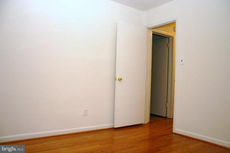 1110 Ednor Road Silver Spring, MD 20905 - Photo 22 of 30 a view of an empty room with wooden floor and closet