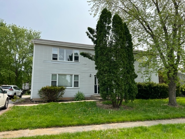 489 Eisenhower Street, Unit 1 Marengo, IL 60152 - Photo 1 of 1 a front view of a house with a garden
