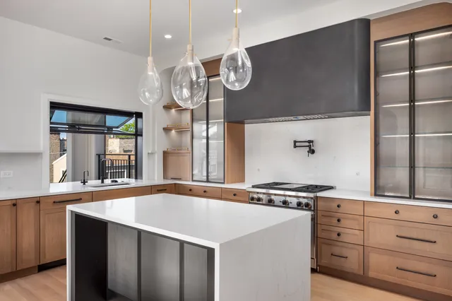 a kitchen with stainless steel appliances a refrigerator and a stove top oven