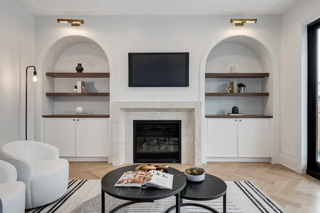 a kitchen with granite countertop a stove and a view of living room