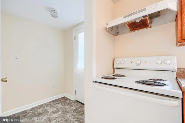 a kitchen with a stove a sink and a refrigerator