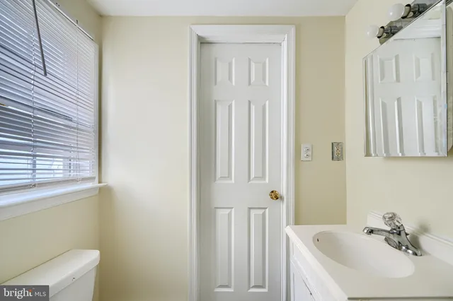 wooden floor to ceiling window and a ceiling fan