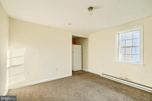 an empty room with a empty space and windows