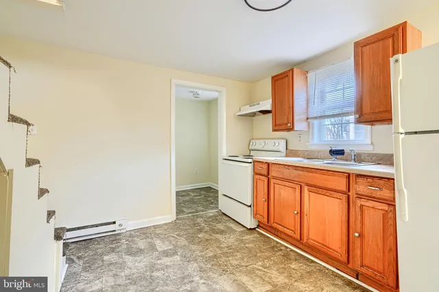 a spacious bathroom with a granite countertop sink and a mirror