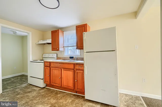 a white refrigerator freezer sitting inside of a kitchen
