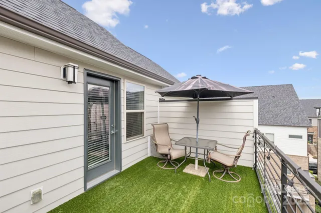 a view of a white house with large windows