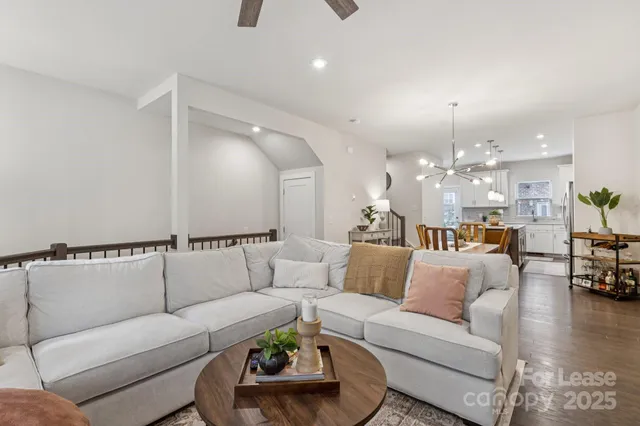 a living room with furniture and kitchen view
