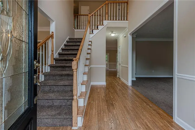 a view of entryway with wooden floor and stairs