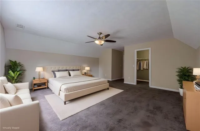 an empty room with a ceiling fan and a window