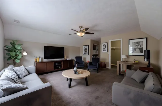 an empty room with fan and entrance