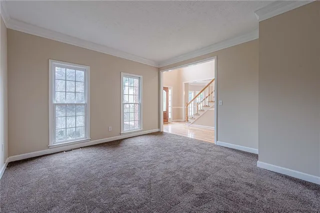 a view of empty room with fireplace and wooden floor