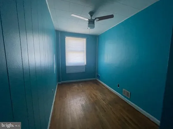 a view of a room with wooden floor and a chair
