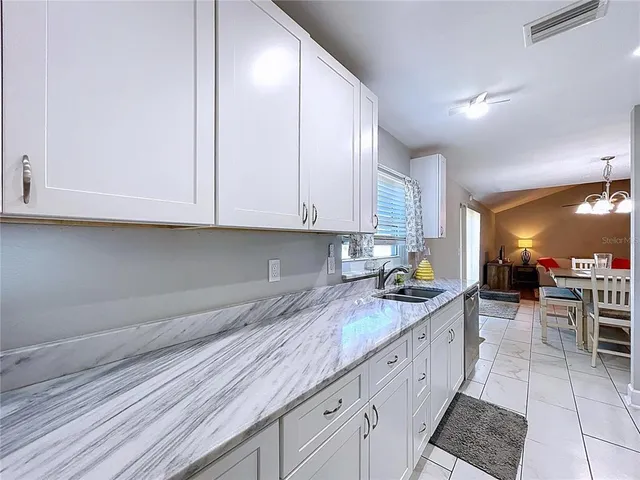 a kitchen with stainless steel appliances a stove a microwave a sink and cabinets