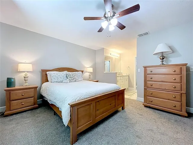 a bedroom with a bed and a couch