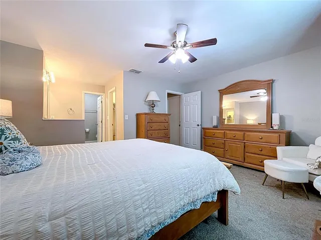 a bedroom with a bed a window and lamps