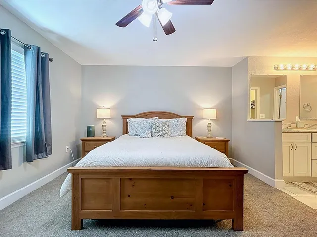 a bedroom with a bed couch and window