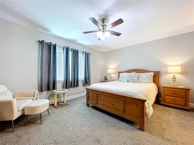 a spacious bedroom with a bed and a chandelier