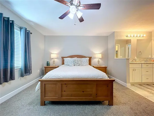 a bathroom with a granite countertop sink a mirror and a shower