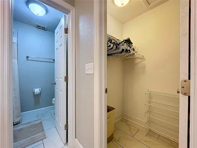 a spacious bathroom with a double vanity sink and a mirror