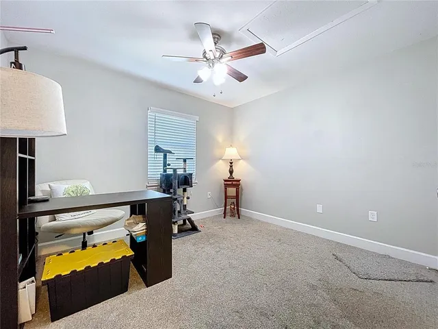 a view of a workspace with furniture and a window