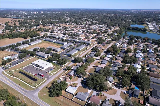 an aerial view of lake with residential houses with outdoor space