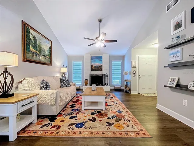 a living room with furniture ceiling fan and a rug