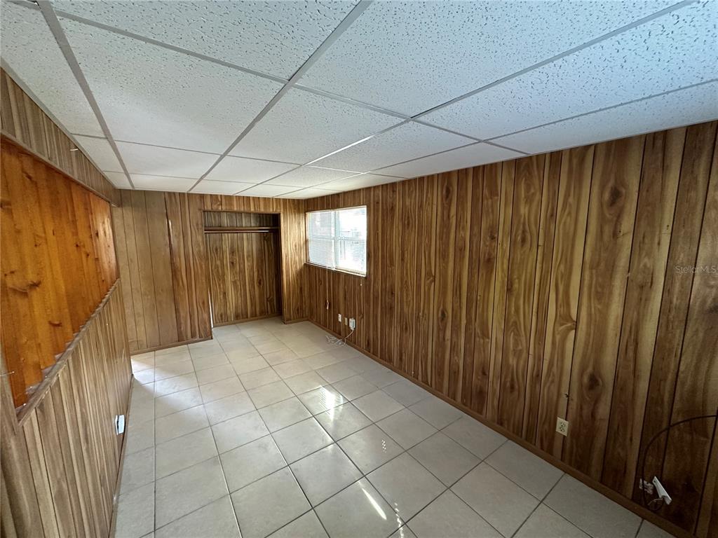 2002 20th Street West, Unit B Bradenton, FL 34205 - Photo 13 of 19 a view of an empty room with wooden walls