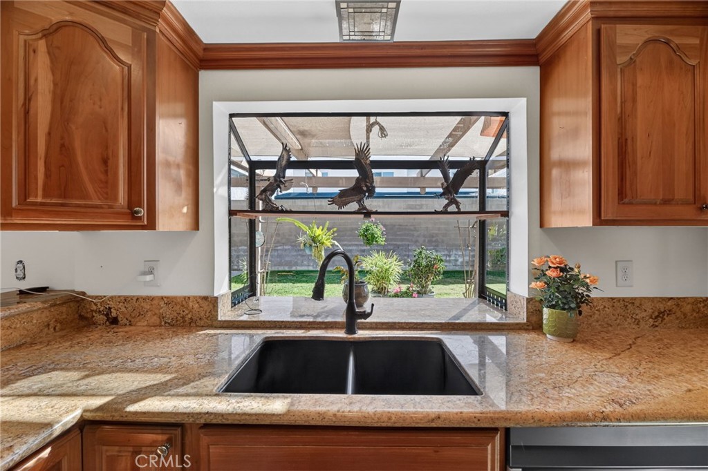 6116 East Paseo Rio Azul Anaheim, CA 92807 - Photo 21 of 54 a kitchen with granite countertop a sink and a stove