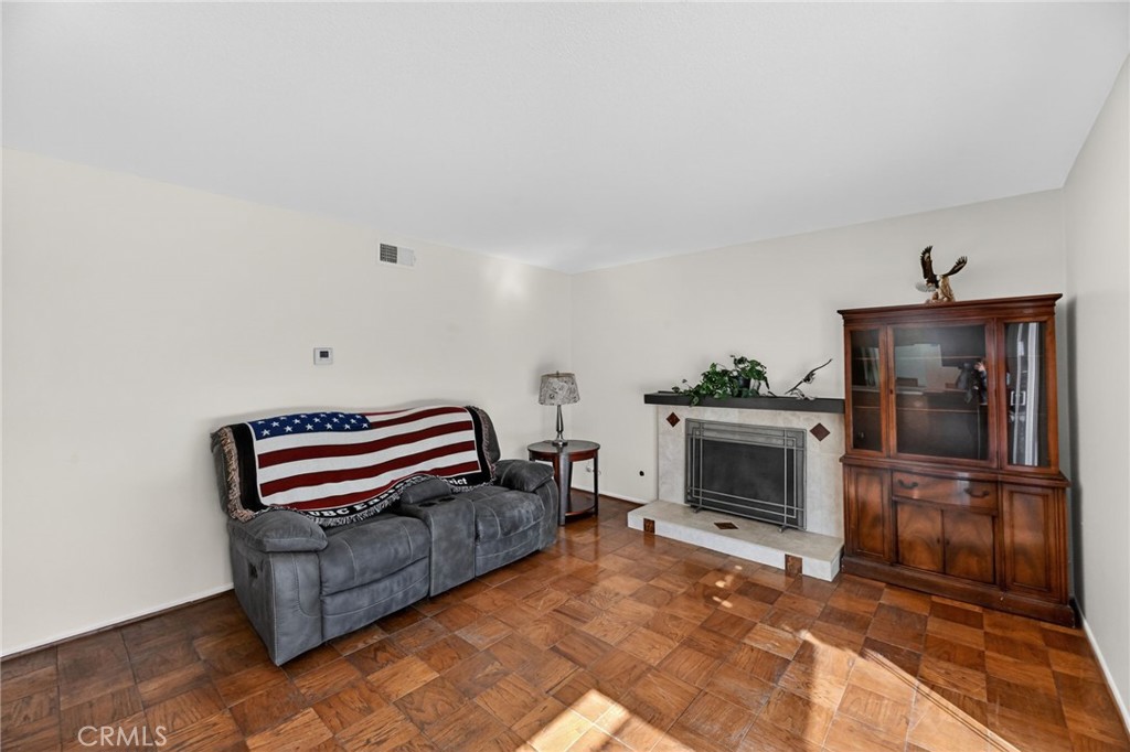 6116 East Paseo Rio Azul Anaheim, CA 92807 - Photo 24 of 54 a bedroom with furniture and a fireplace